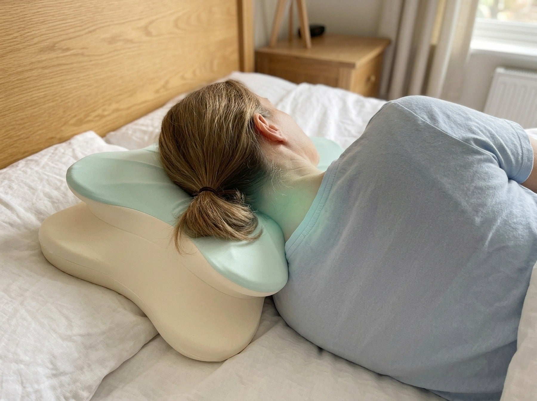 The head resting level on the pillow, seen from behind