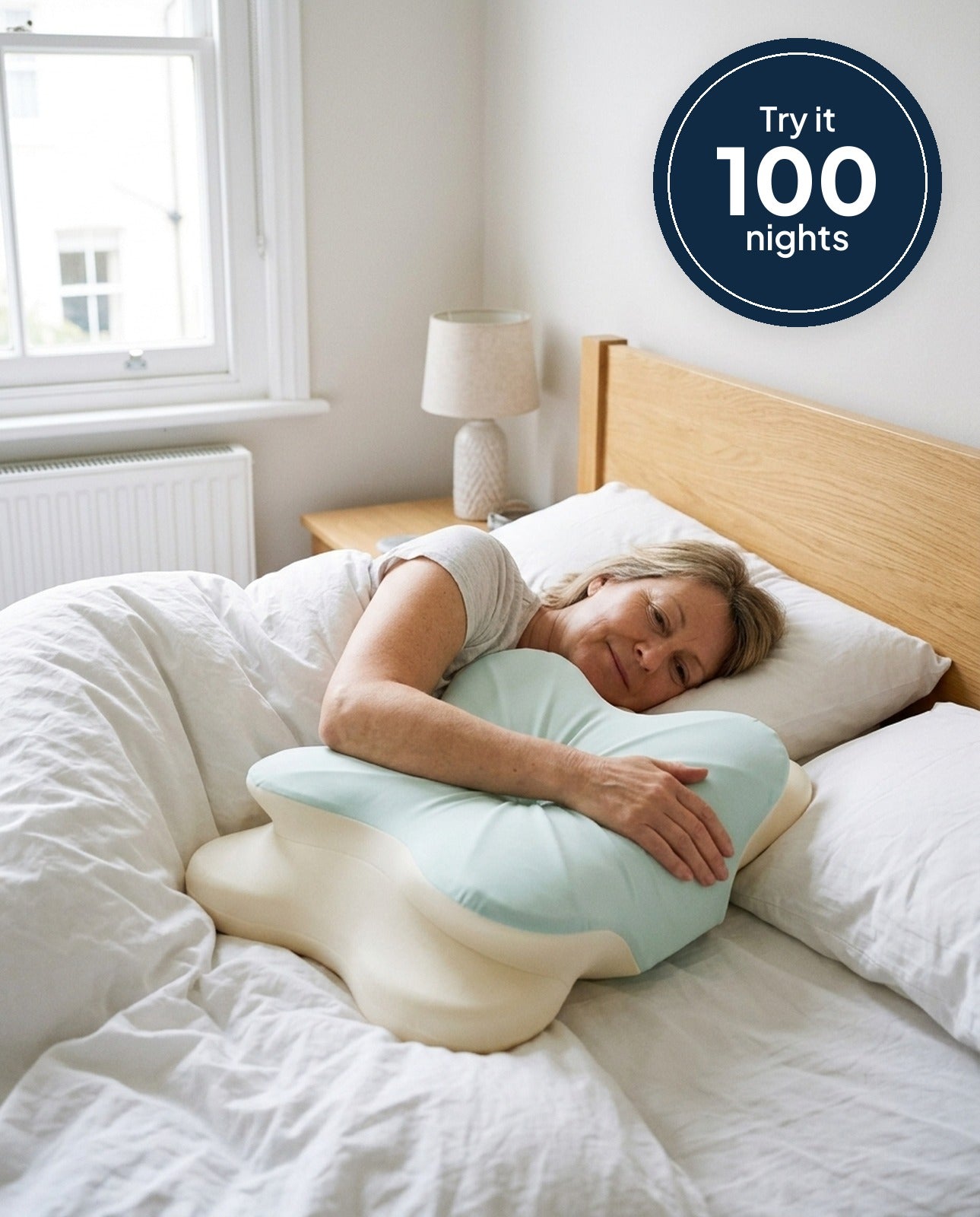 Woman hugging the NattieSide pillow in bed